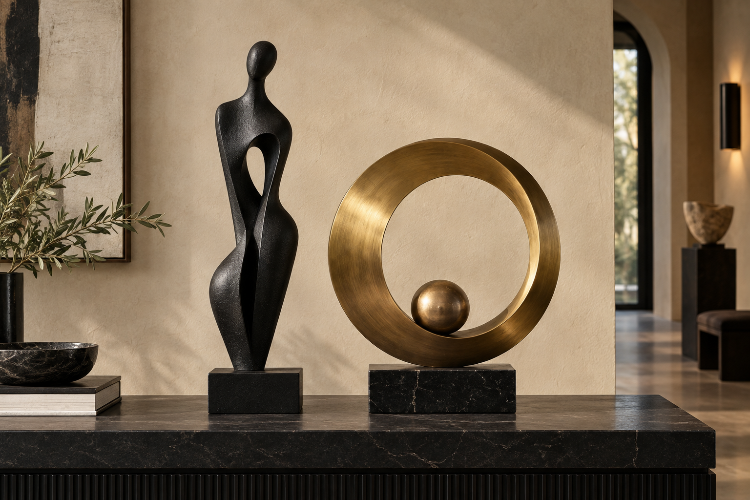 Black and brass abstract sculptures on a stone console
